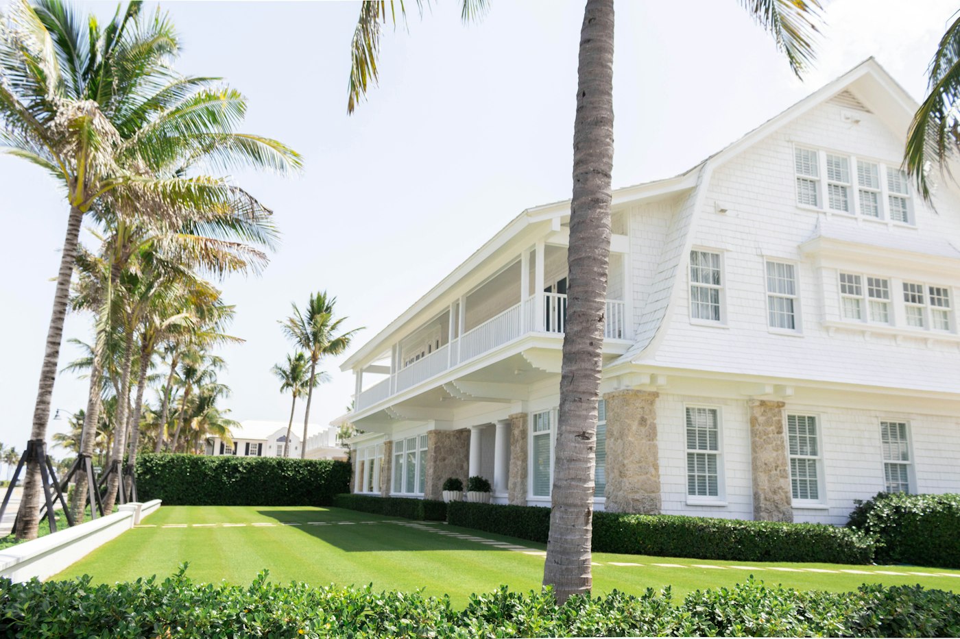 White South Florida home among palm trees